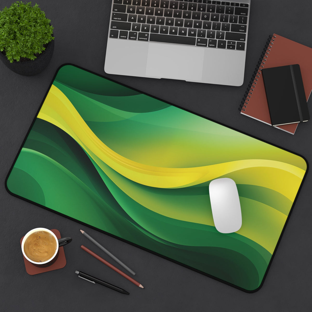Abstract Desk Mat 12 × 22 inches overhead on a desk with laptop, plant, notebooks, mouse, cup and pens.