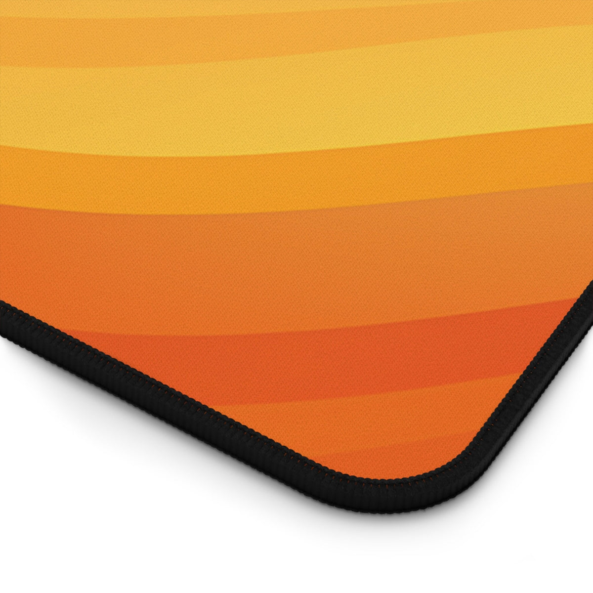Abstract Lava Desk Mat detail of the curved corner with black stitched edge on white background.