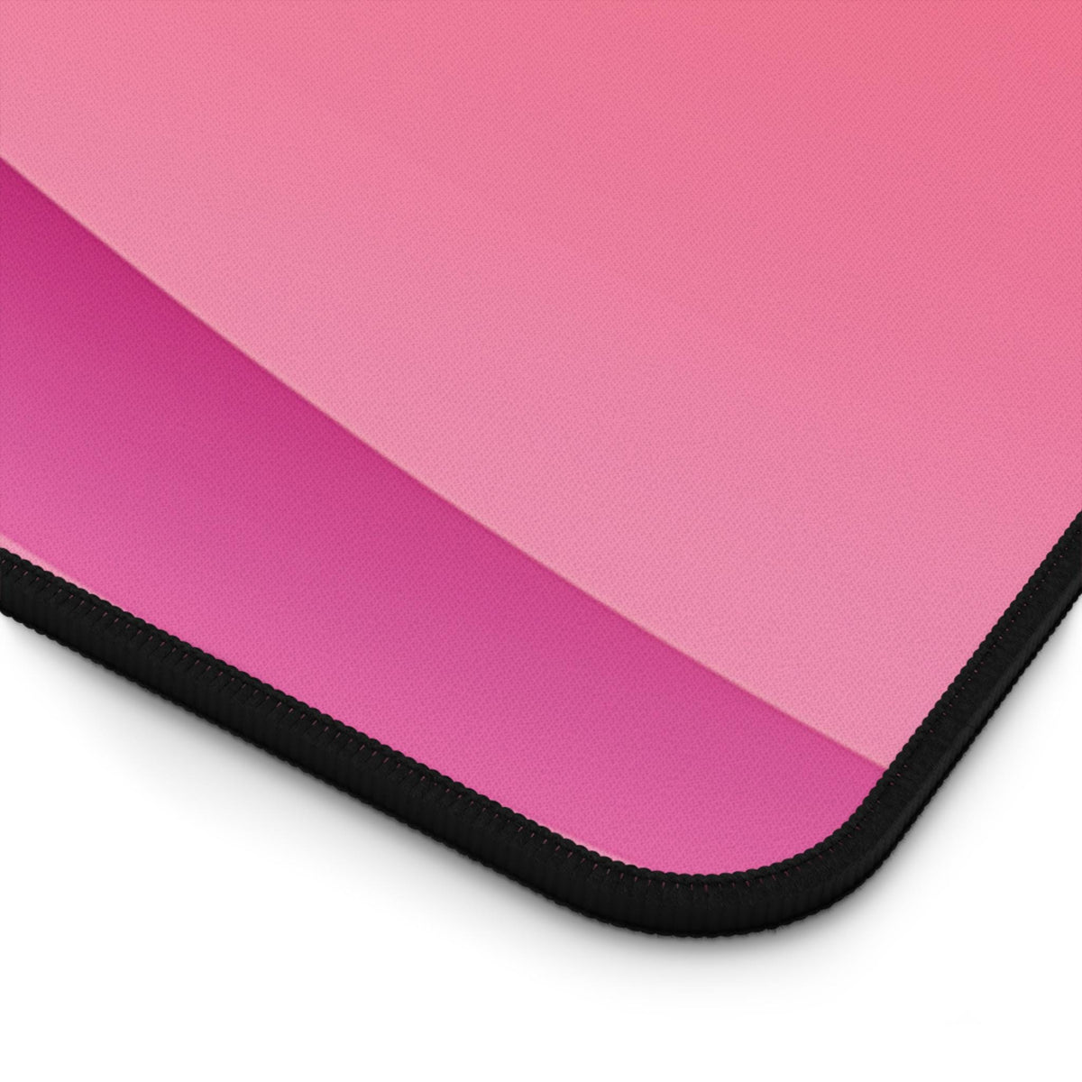 Abstract Desk Mat close-up of pink-to-magenta gradient corner with black stitched edge.