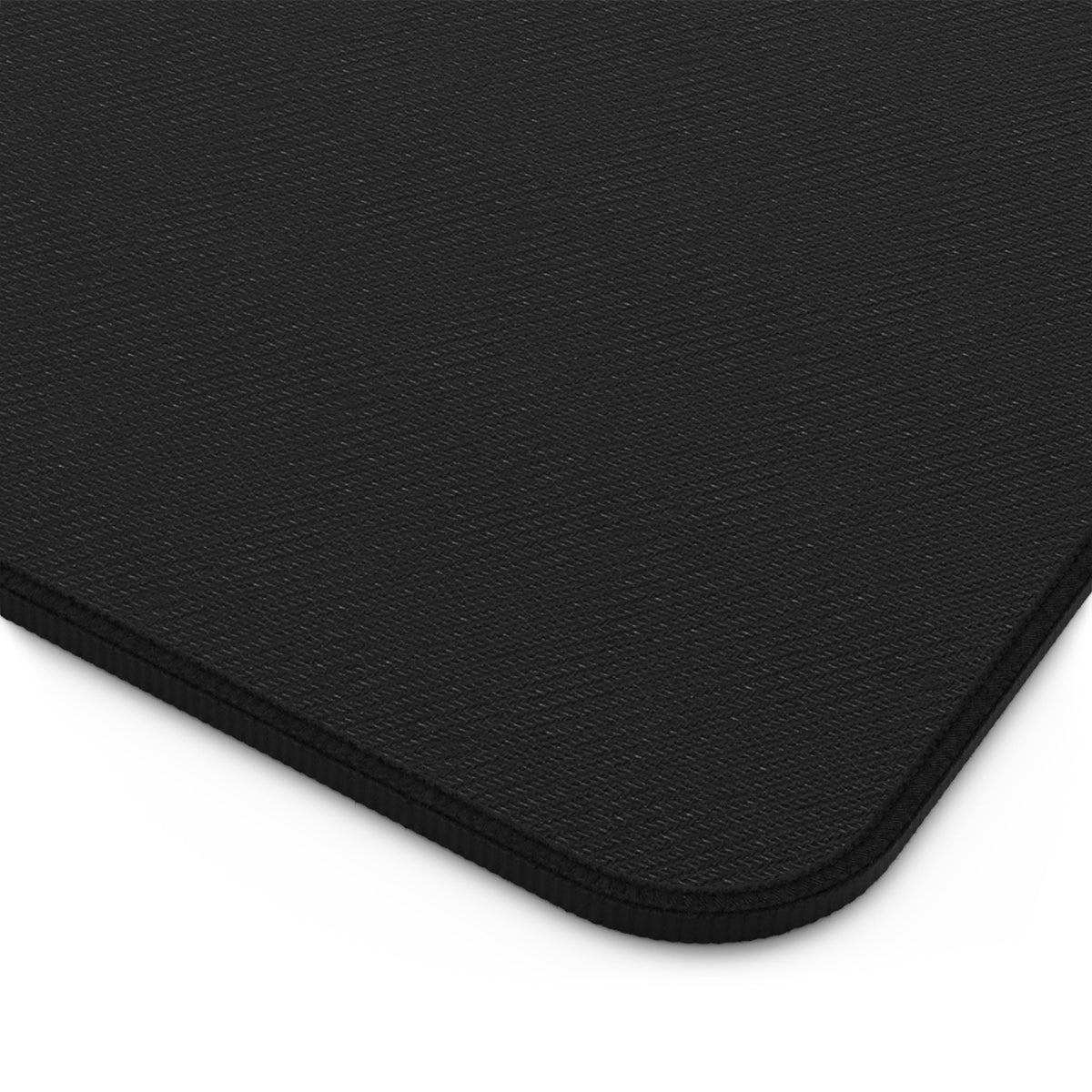 Abstract Red Wave Desk Mat shown in close-up of its black textured corner and stitched edge on white.