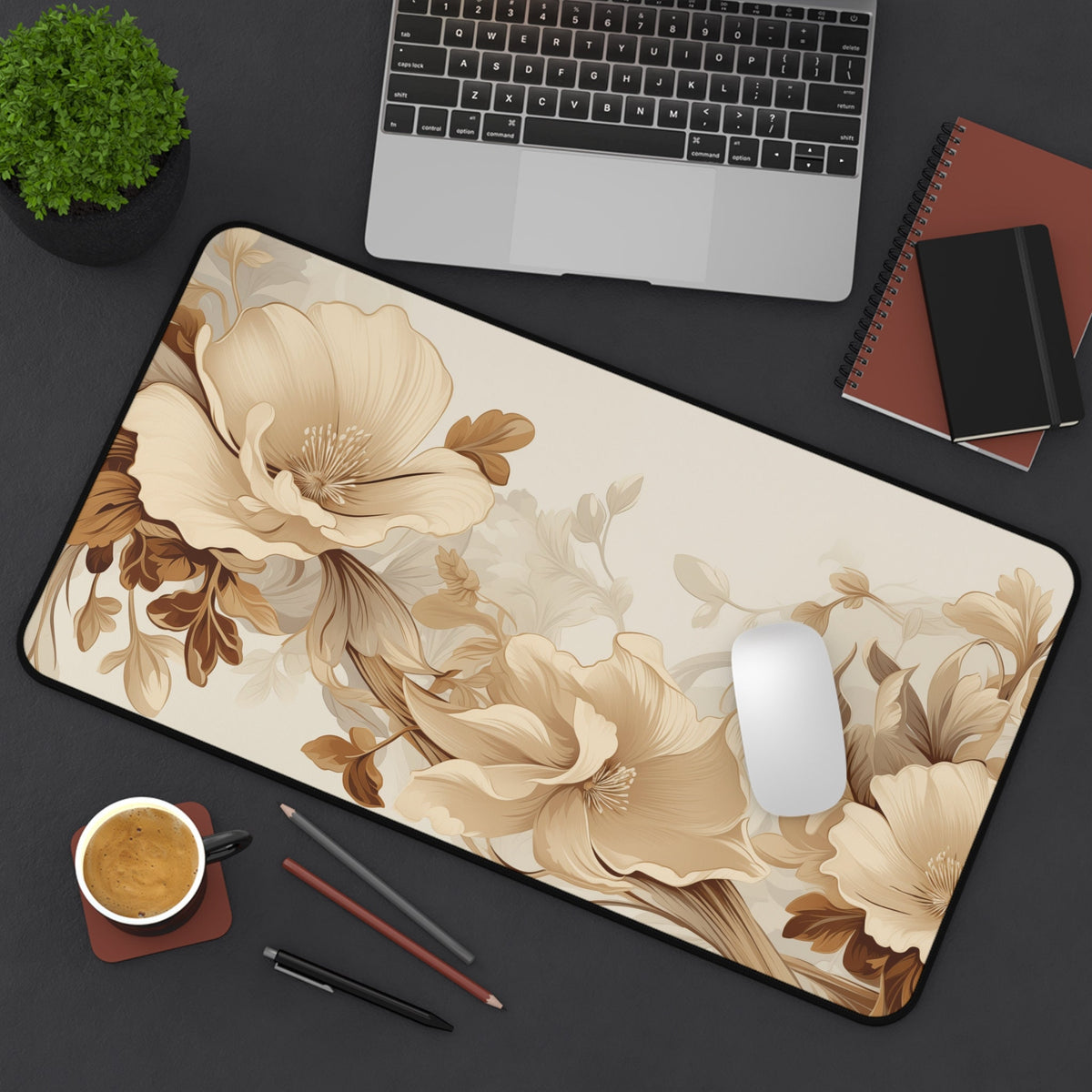 Art Nouveau Floral Desk Mat from above on a desk with laptop, mouse, plant, coffee, pencils and notebooks, 12 × 22 inches.