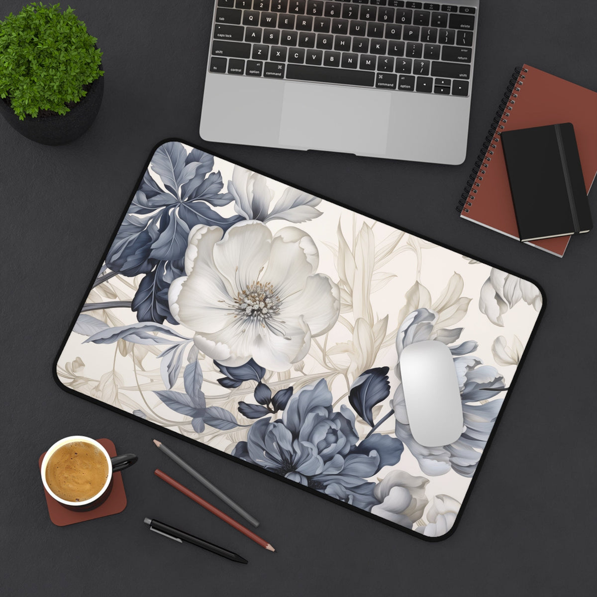Art Nouveau Floral Desk Mat in overhead view on dark desk beside laptop, plant, coffee, pencils and mouse, 12 × 18 inches.