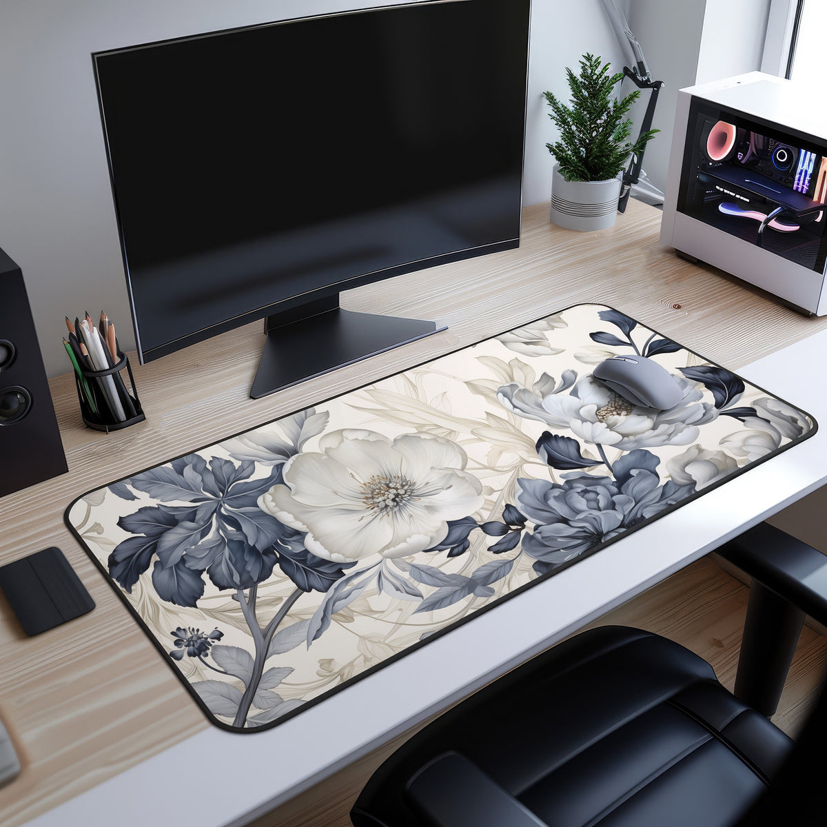 Art Nouveau Floral Desk Mat on a wooden desk beneath a monitor, with mouse, plant and PC tower nearby.