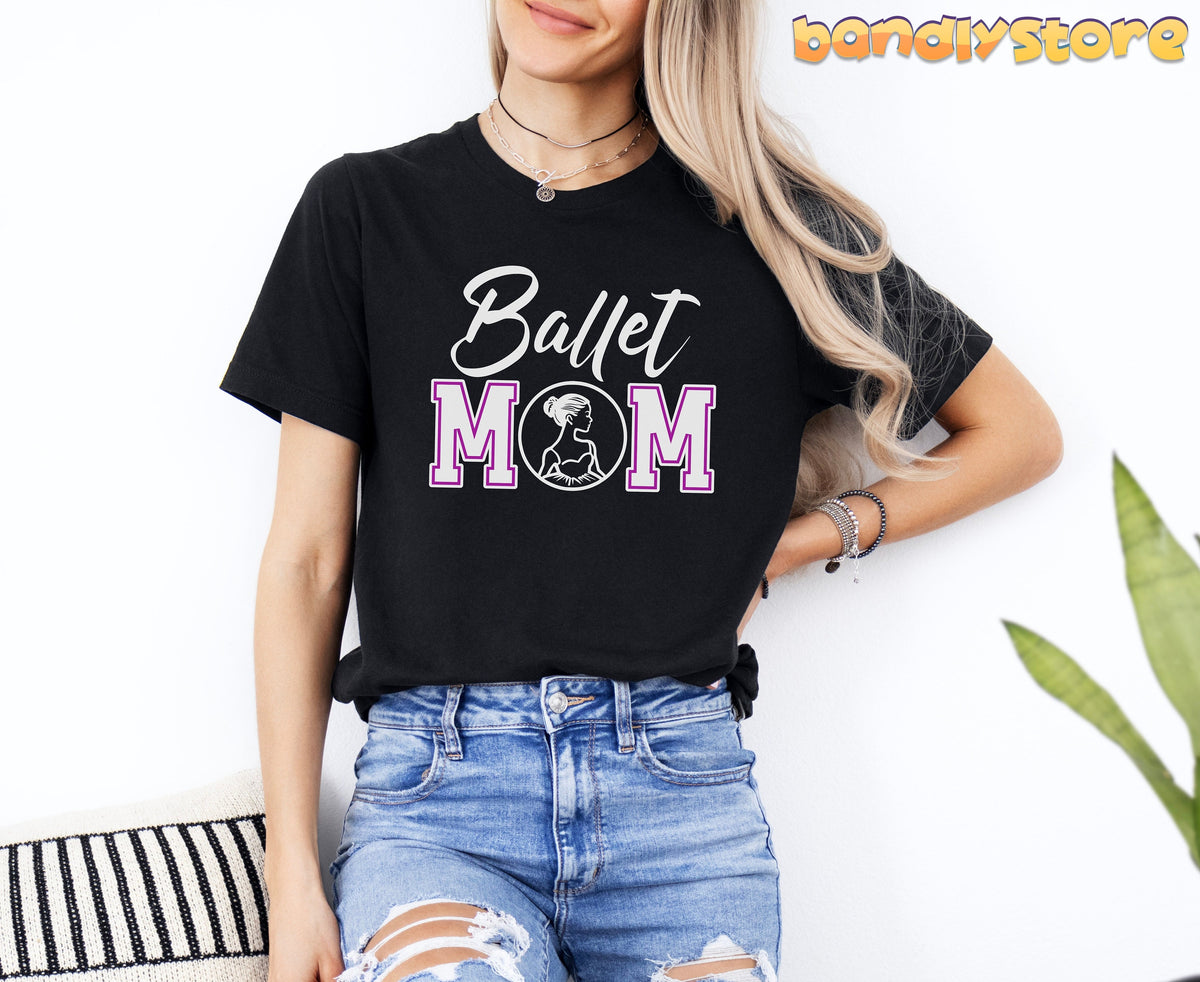 Ballet Mom T-Shirt in black worn by a woman against a white wall next to a plant and striped cushion.