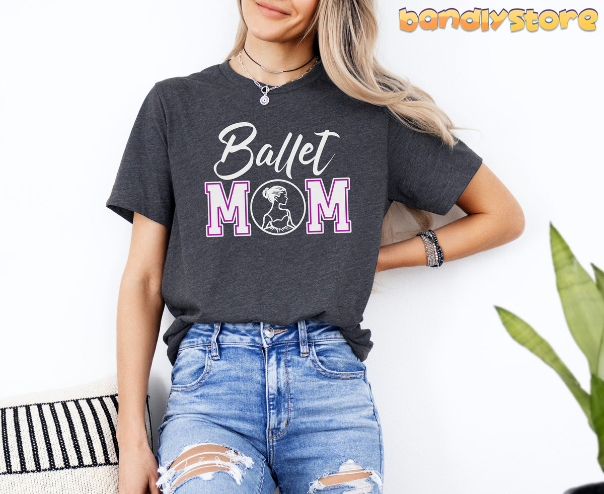 Ballet Mom T-Shirt in Dark Grey Heather on seated woman against white wall beside plant and striped pillow.