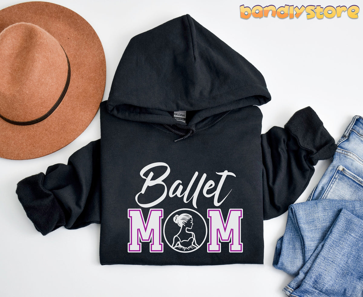 Ballet Mom Hoodie in black laid flat on white beside a brown hat and blue jeans.