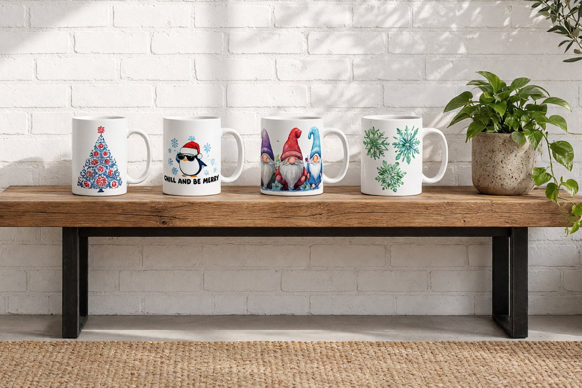 Four Christmas ceramic mugs on a wooden console table against a sunlit white brick wall