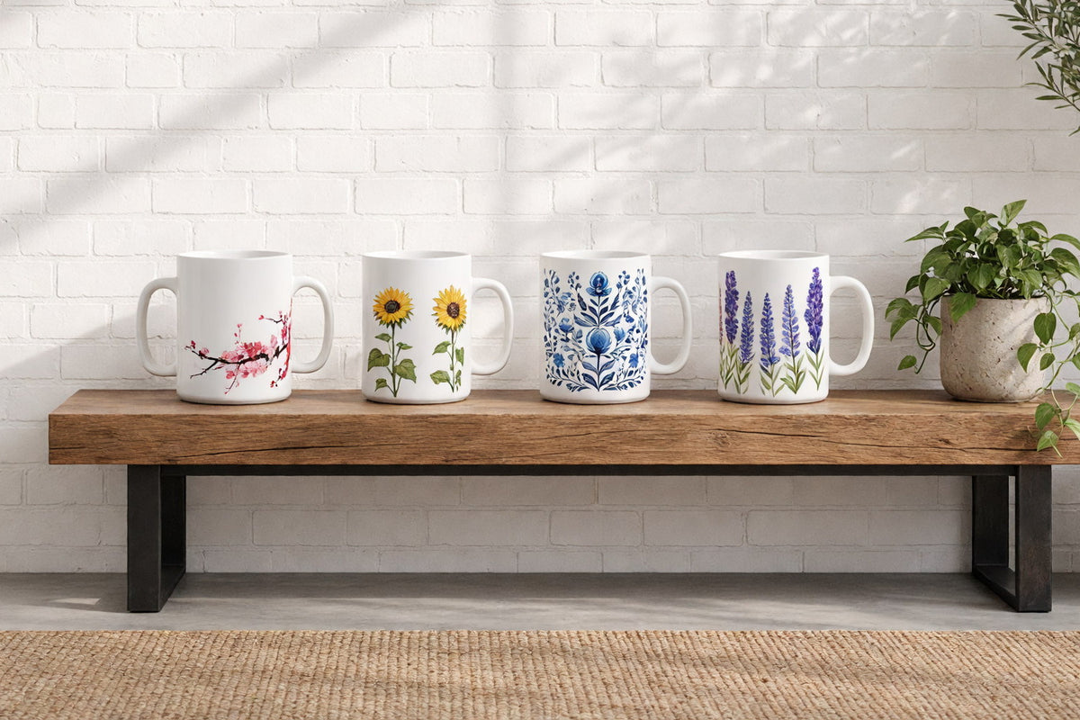 Four floral ceramic mugs on a wooden console table against a sunlit white brick wall