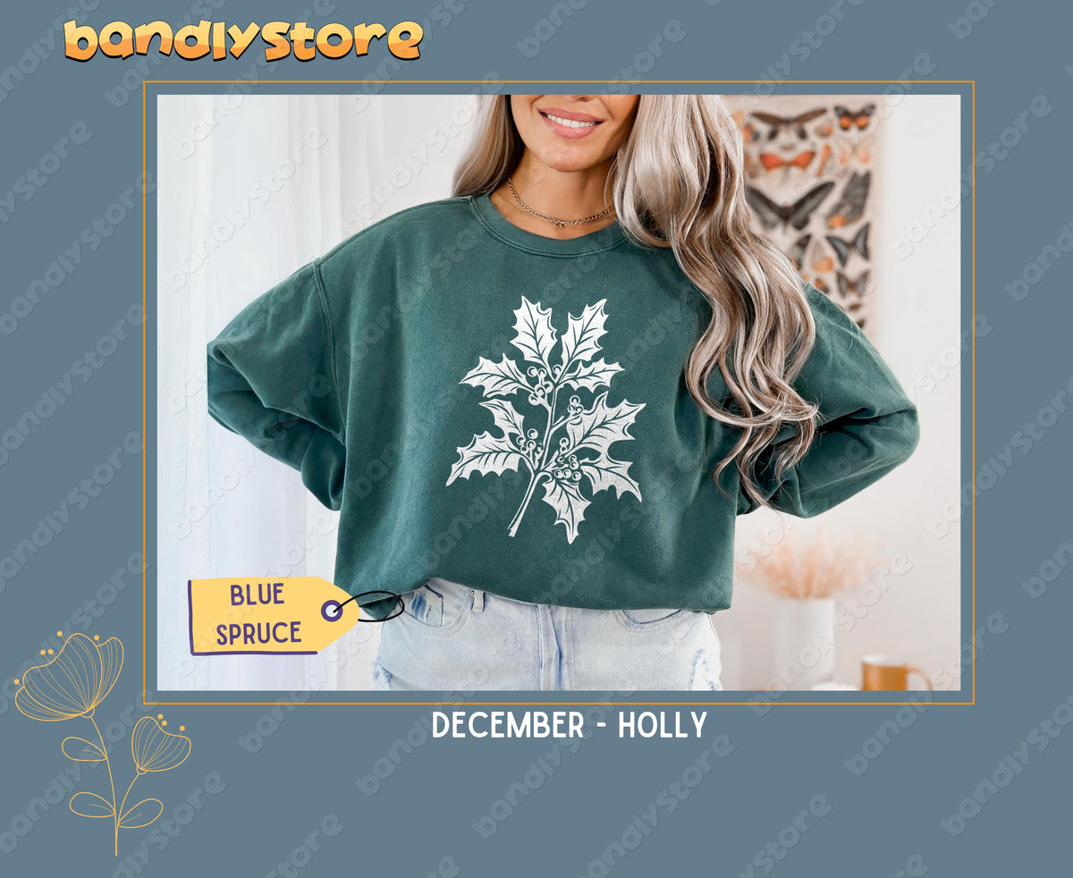 July Larkspur Birth Flower Sweatshirt in Blue Spruce on a model standing indoors near curtains and a butterfly print.