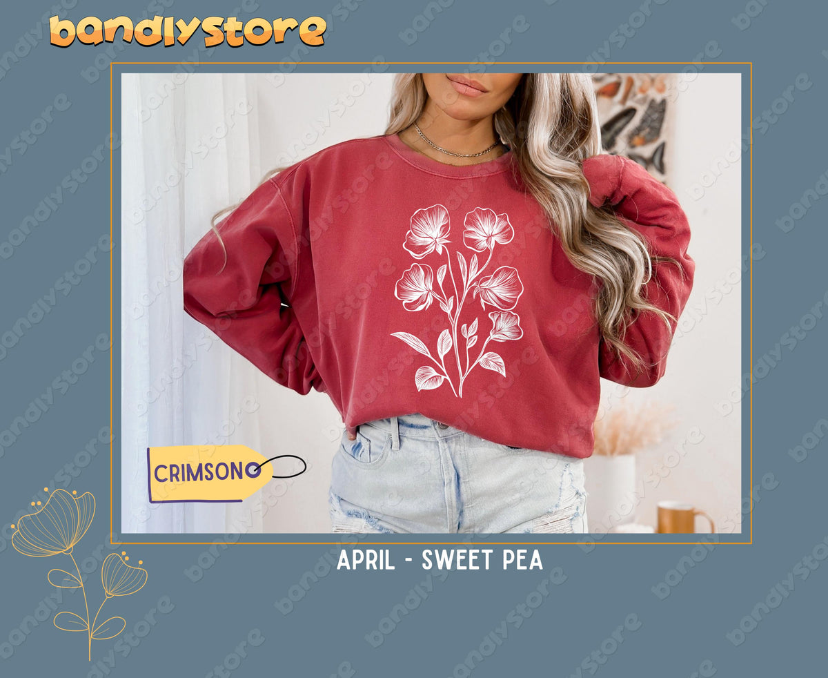 July Larkspur Birth Flower Sweatshirt in crimson on a model facing forward indoors by sheer curtains.
