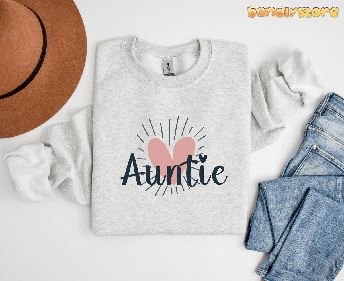 Boho Auntie Sweatshirt in ash laid flat on white beside a brown hat and blue jeans.