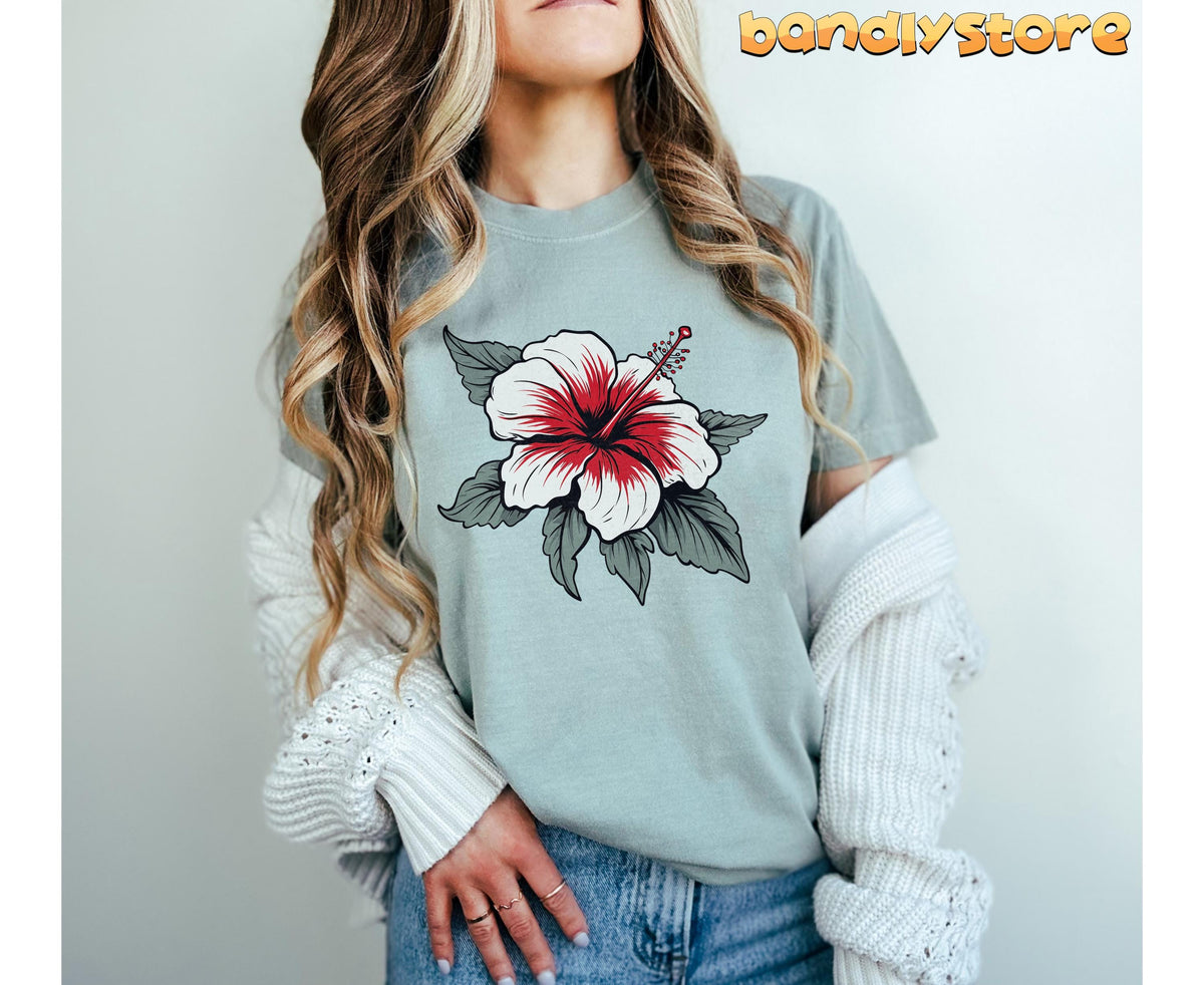 Boho Hibiscus Flower T-Shirt in Bay, worn by a person with long wavy hair, cropped front view against a plain wall.
