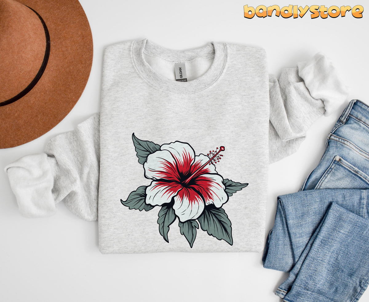 Boho Hibiscus Sweatshirt in ash laid flat next to a brown hat and blue jeans on white background.