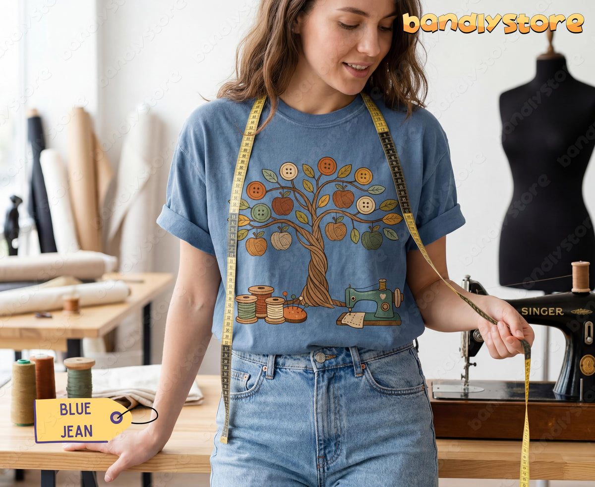 Boho Sewing T-Shirt in blue jean worn by a woman in a sewing studio with measuring tape, spools and machine.