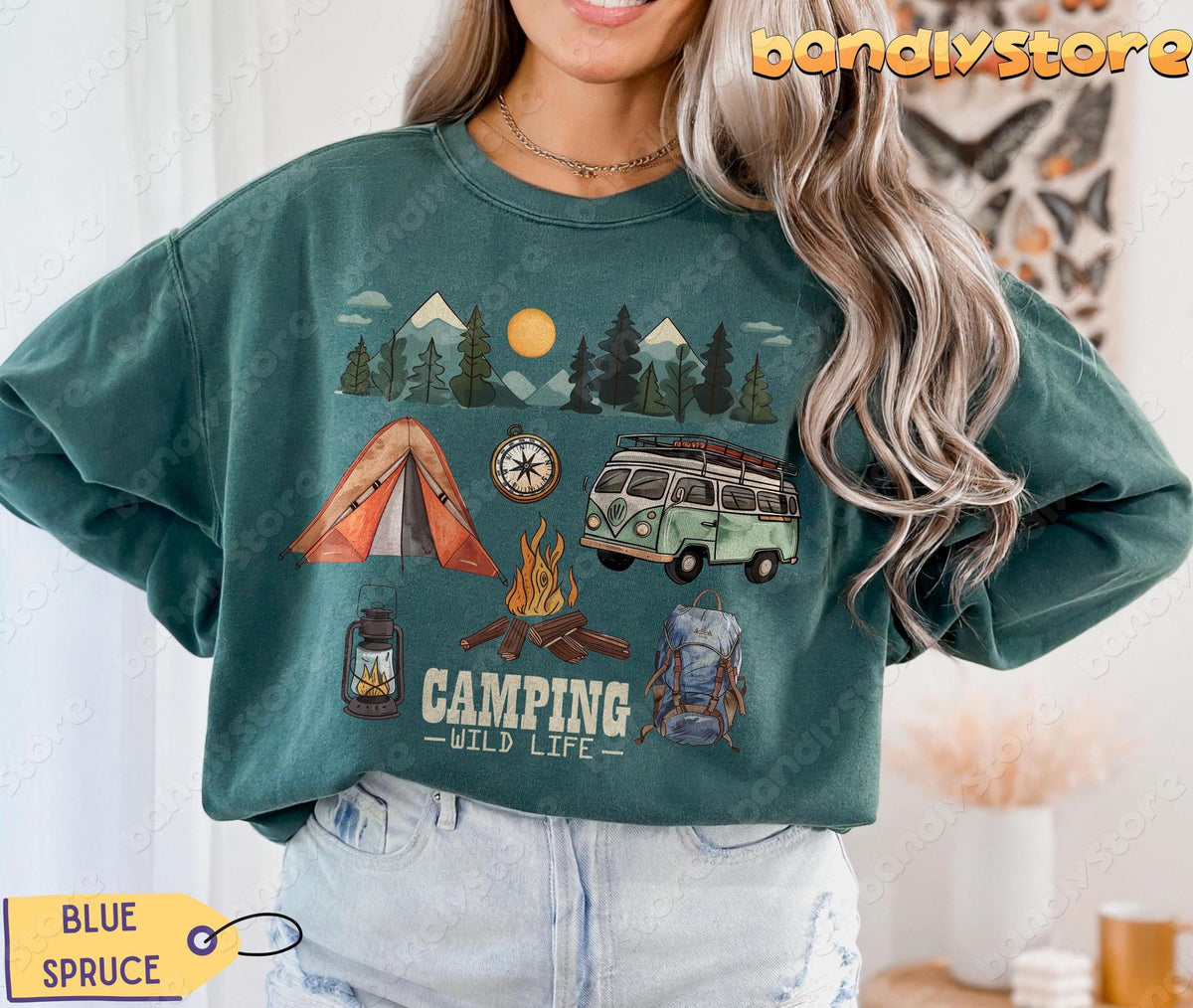 Camping Wildlife Sweatshirt in Blue Spruce, front view on a model with tent, van, campfire and mountain scene.