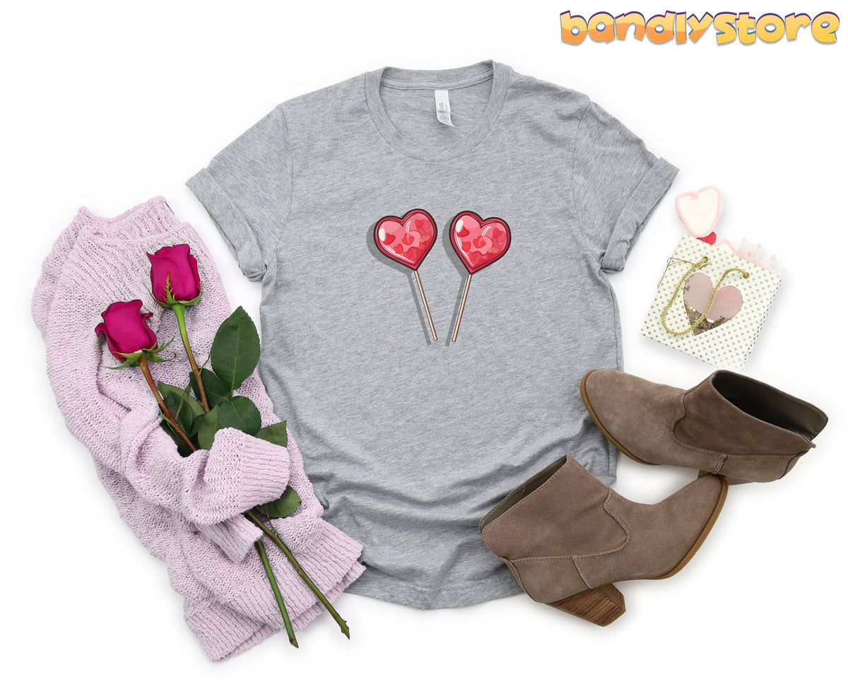 Cute Candy Hearts T-Shirt in Athletic Heather flat-laid with roses, sweater, boots and gift bag.