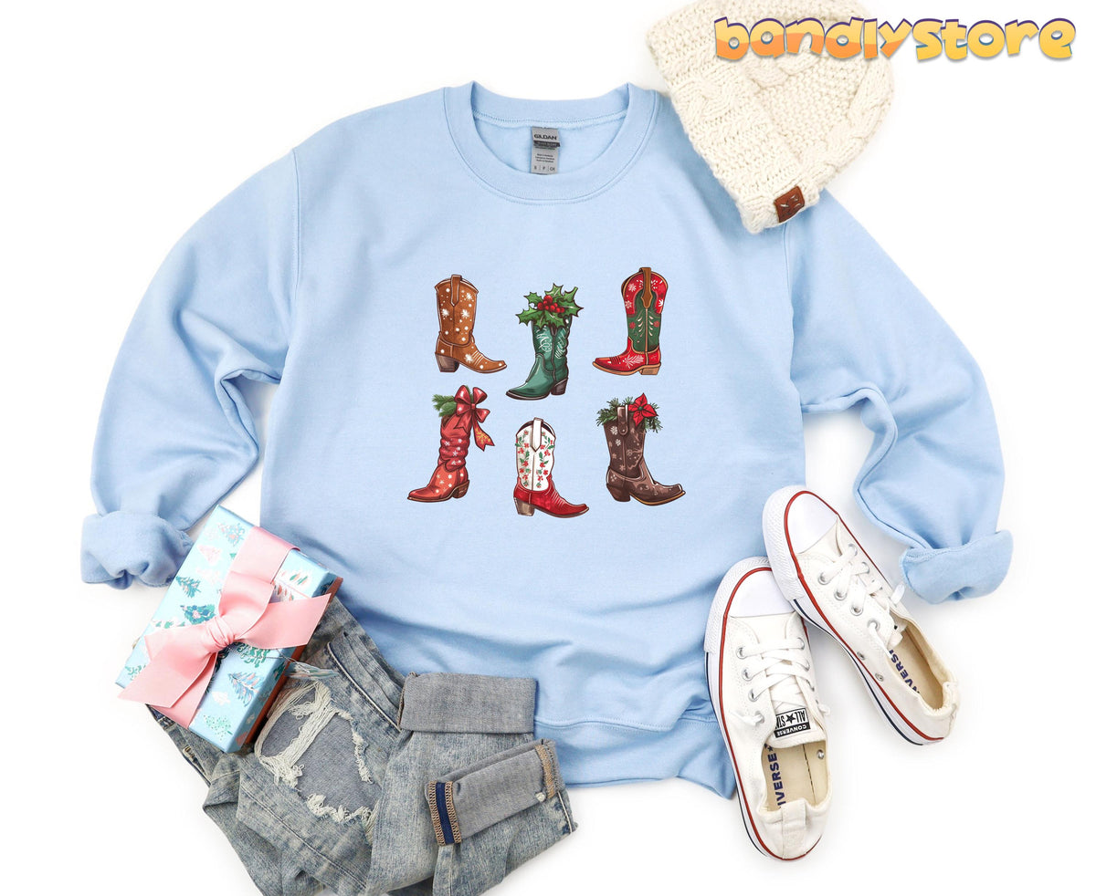 Christmas Cowgirl Boots Sweatshirt in light blue flat-laid from above with beanie, gift, jeans and sneakers.