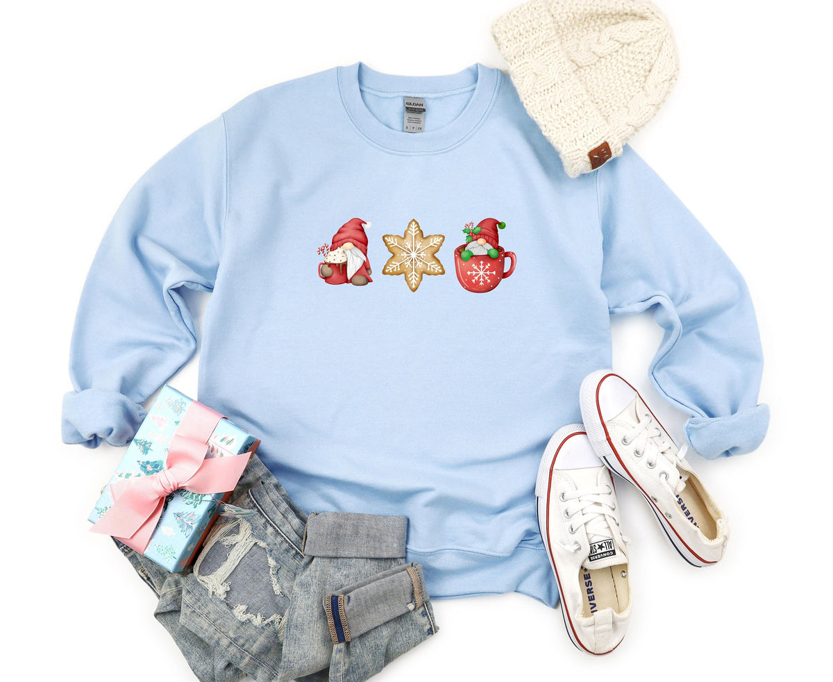 Christmas Gnomes Gingerbread Sweatshirt in light blue laid flat with beanie, gift, jeans and sneakers nearby.