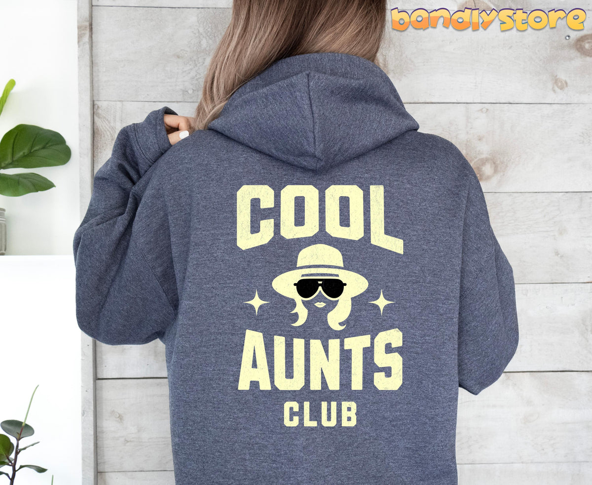 Cool Aunts Club Hoodie in Dark Heather, rear view against wood wall with green plant.