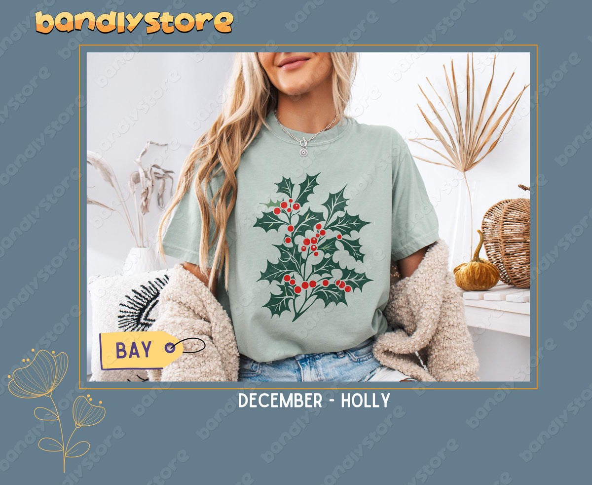Custom Birth Month Flower T-Shirt in Bay on a seated model indoors beside dried plants, pumpkin and wicker basket.