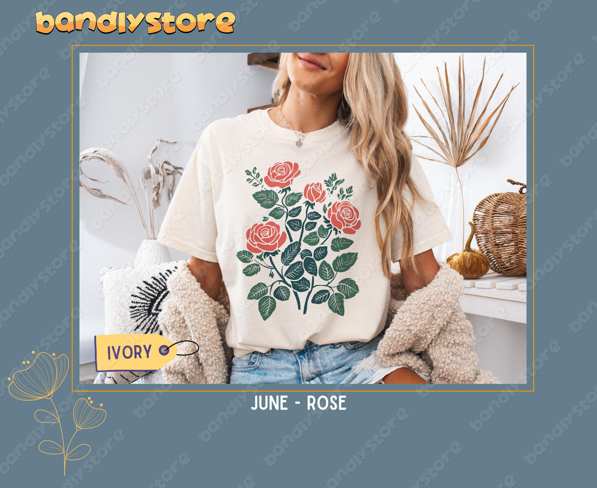 Custom Birth Month Flower T-Shirt in Ivory, worn front-facing indoors among dried plants, a pillow and woven baskets.