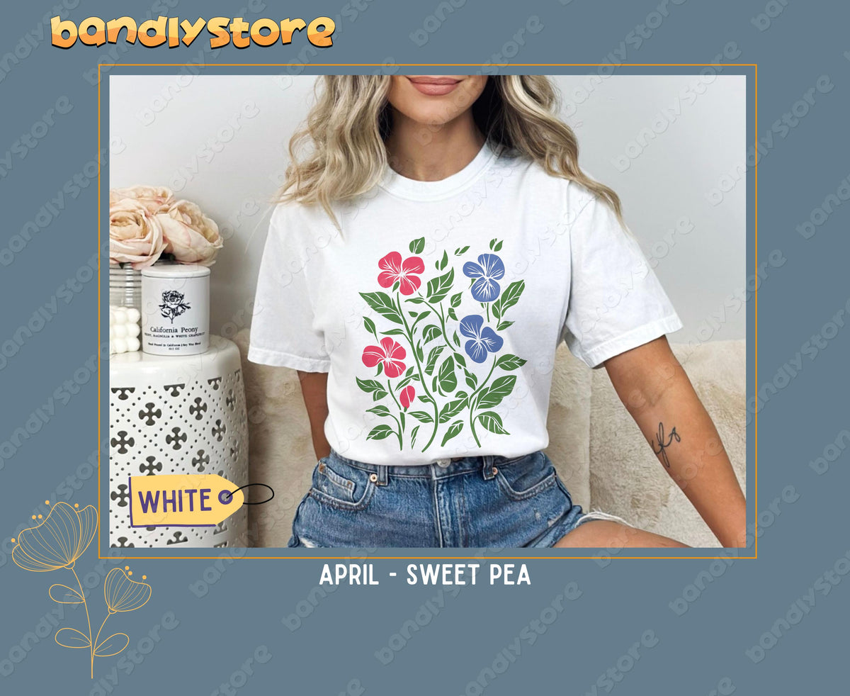 Custom Birth Month Flower T-Shirt in white worn by a seated woman next to a side table with flowers and candle.