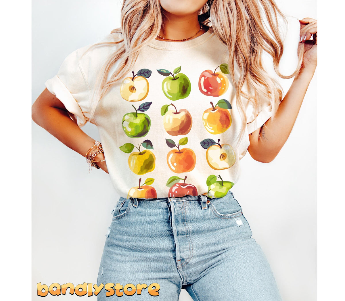 Cute Apples T-Shirt front view on a person with long blonde hair and blue jeans against a plain white backdrop in Ivory