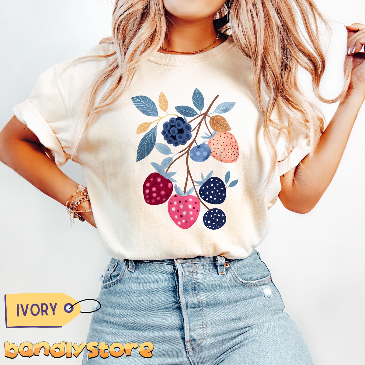 Cute Boho Strawberry T-Shirt in ivory worn front-view by a model with jeans against a plain white backdrop.