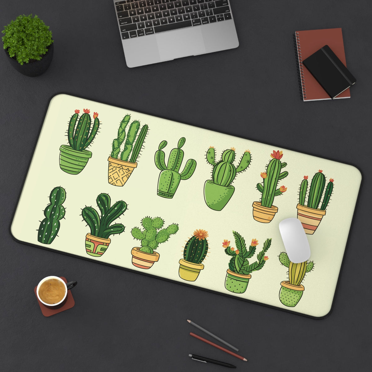 Cute Cartoon Cactus Desk Mat 16 × 32 inches top-down on dark desk beside laptop, plant, coffee, pens and mouse.