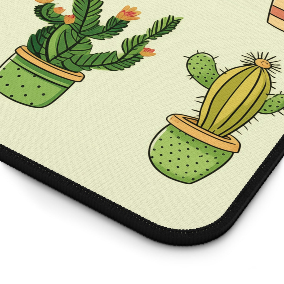 Cute Cartoon Cactus Desk Mat detail of the corner showing potted cacti illustrations and black stitched edge.