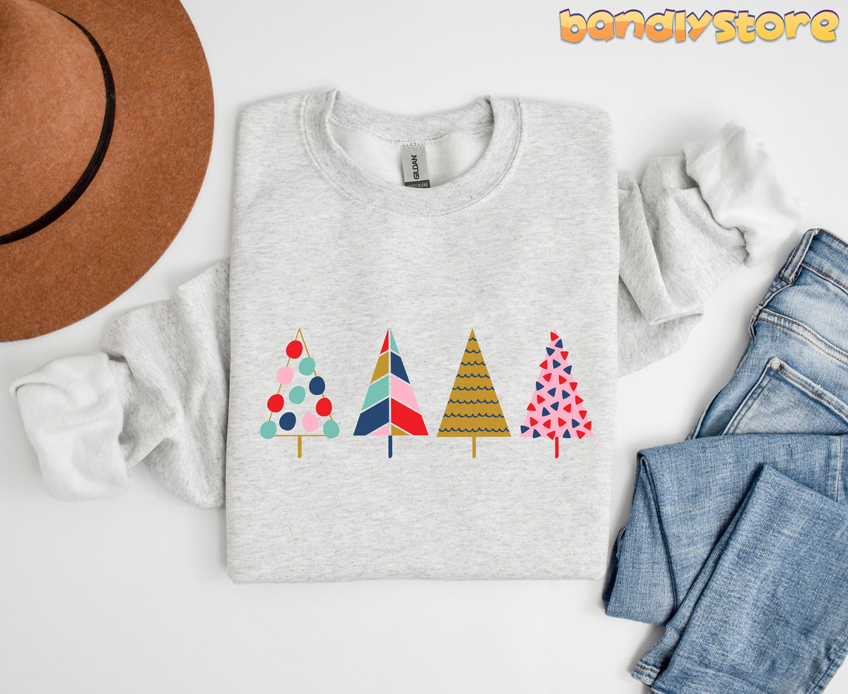 Cute Christmas Trees Sweatshirt in ash folded flat on white next to a hat and jeans.