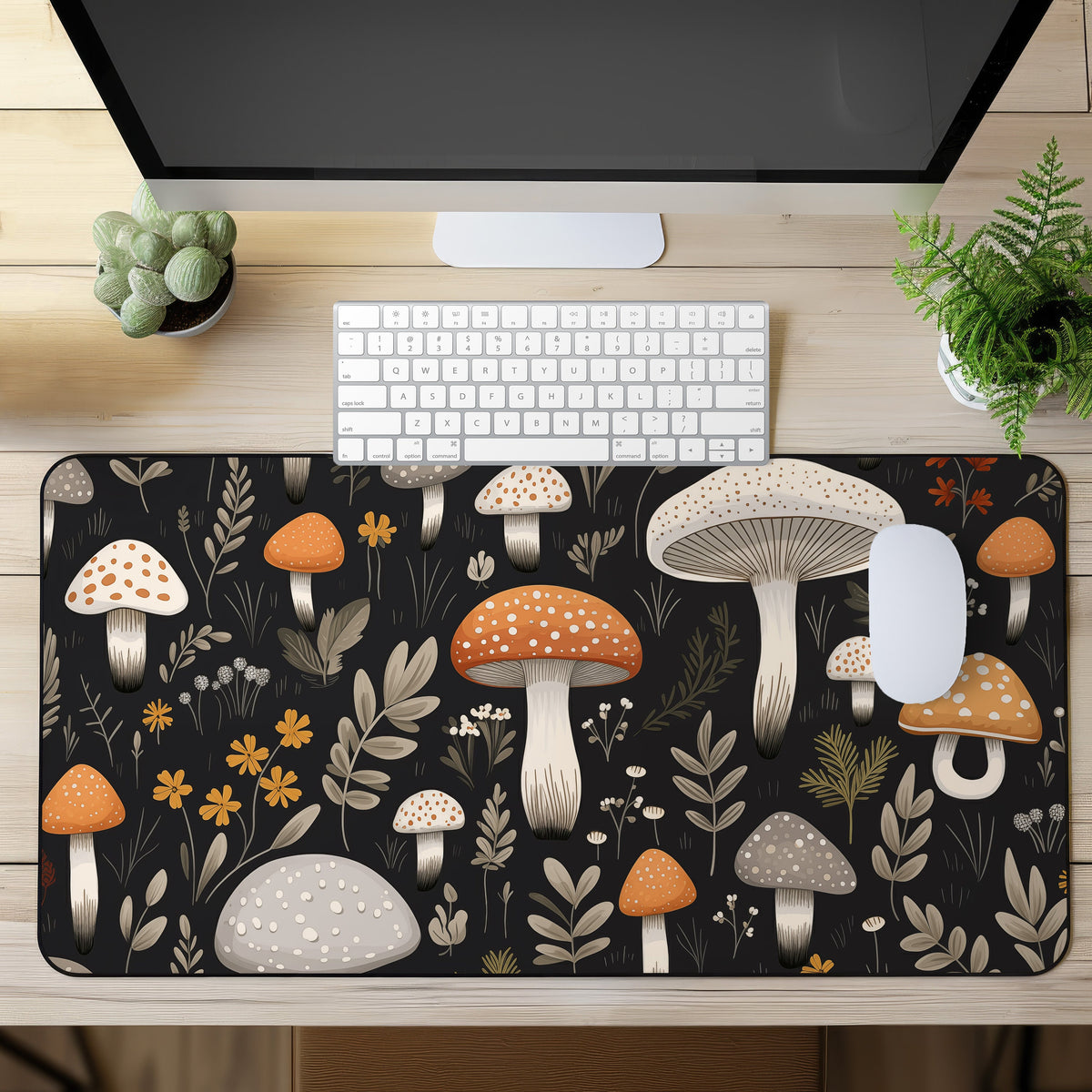 Cute Mushroom Desk Mat in overhead view on a wooden desk with monitor, keyboard, mouse and plants.