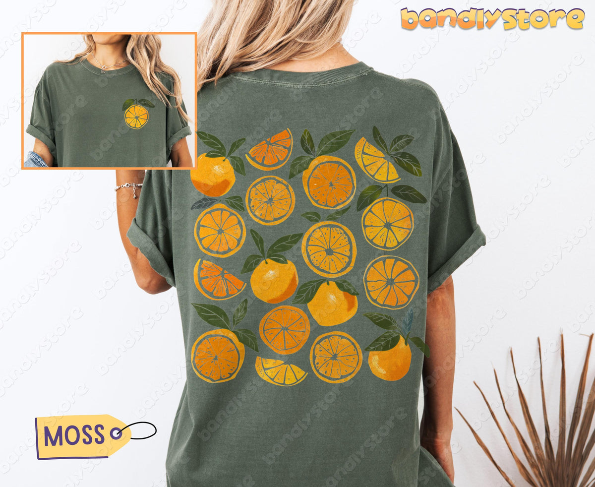 Cute Oranges T-Shirt with Back Print in moss, back view on model with front inset and plant beside.