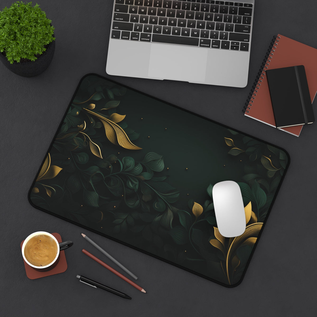 Botanical Leaves Desk Mat in 12 × 18 inches from above on a desk beside laptop, plant, notebooks, coffee, pens and mouse.