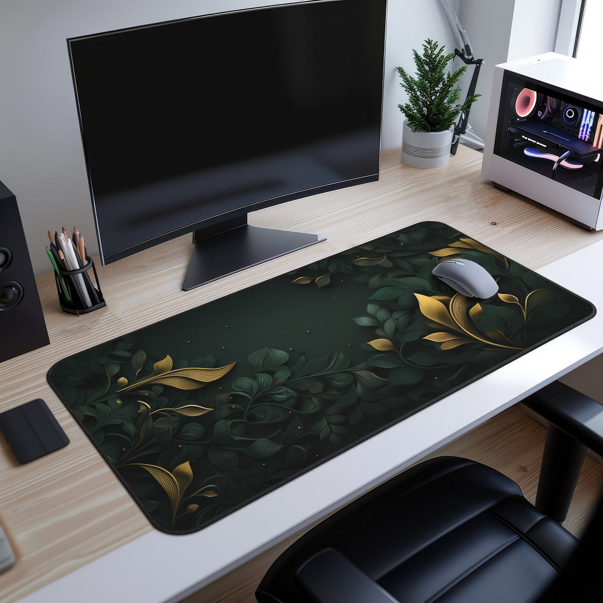 Botanical Leaves Desk Mat on a light wood desk under a monitor, with mouse, plant and PC case beside it in an angled view.