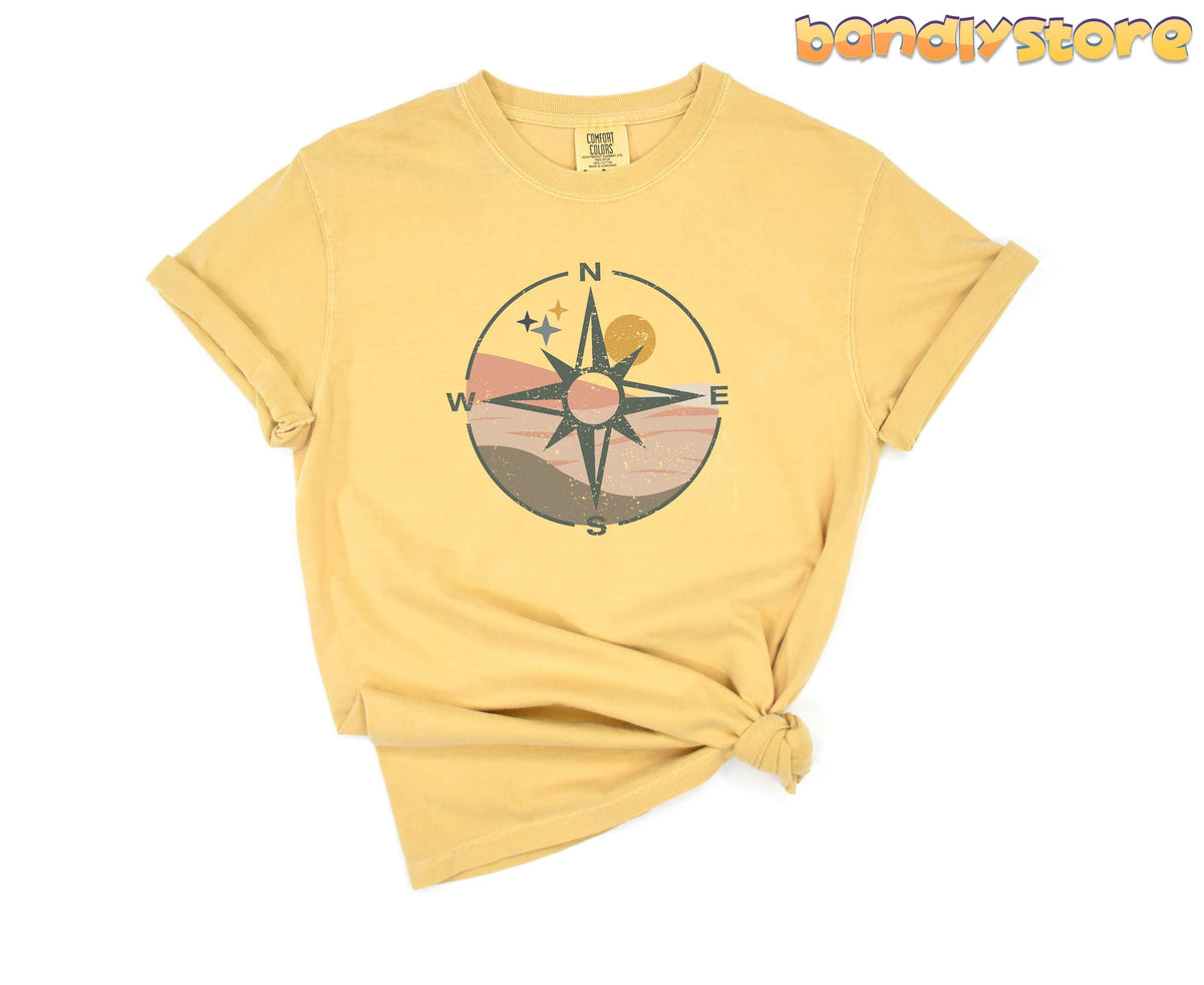 Distressed Compass T-Shirt in mustard on plain white background, front view, rolled sleeves and knotted hem.