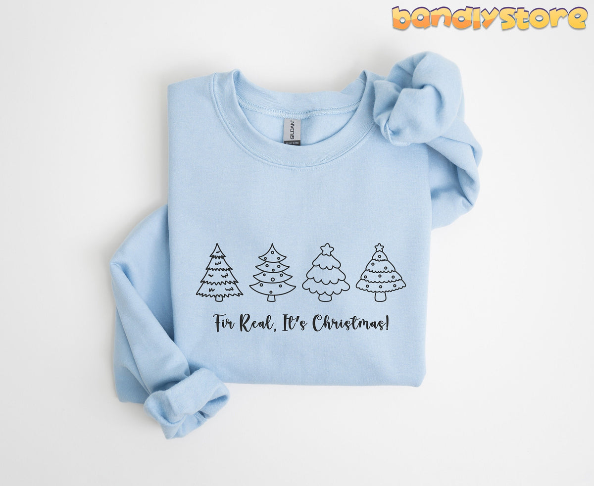 Fir Real It's Christmas Sweatshirt light blue folded flat with four black outline Christmas trees and text centered on white.