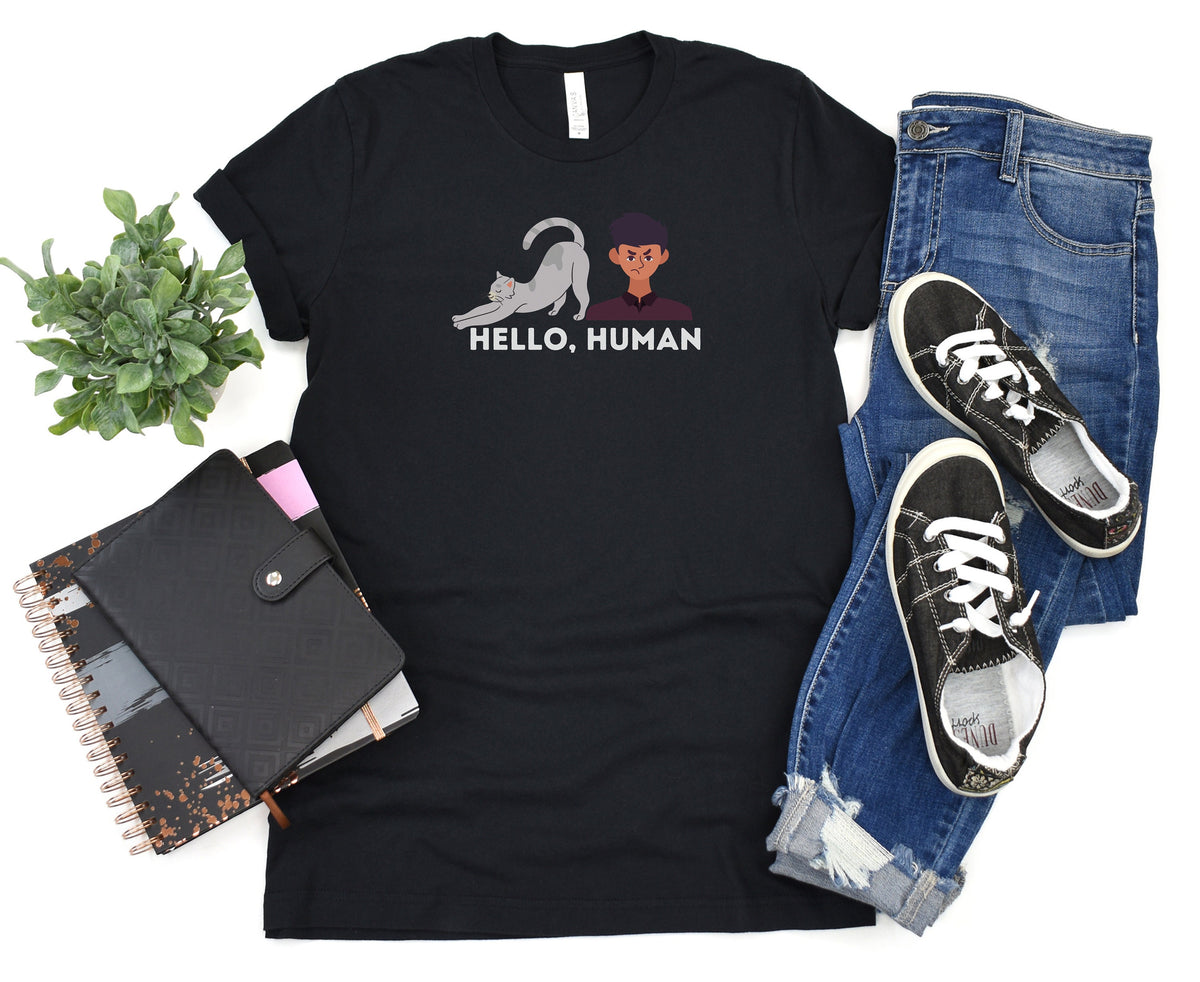 Funny Cat Butt T-Shirt black flat-laid from above beside plant, notebooks, jeans and sneakers.