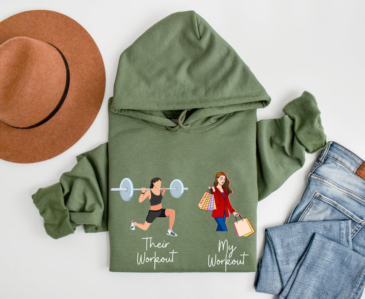 Funny Fitness Hoodie in military green top-down flat lay beside a brown hat and blue jeans.