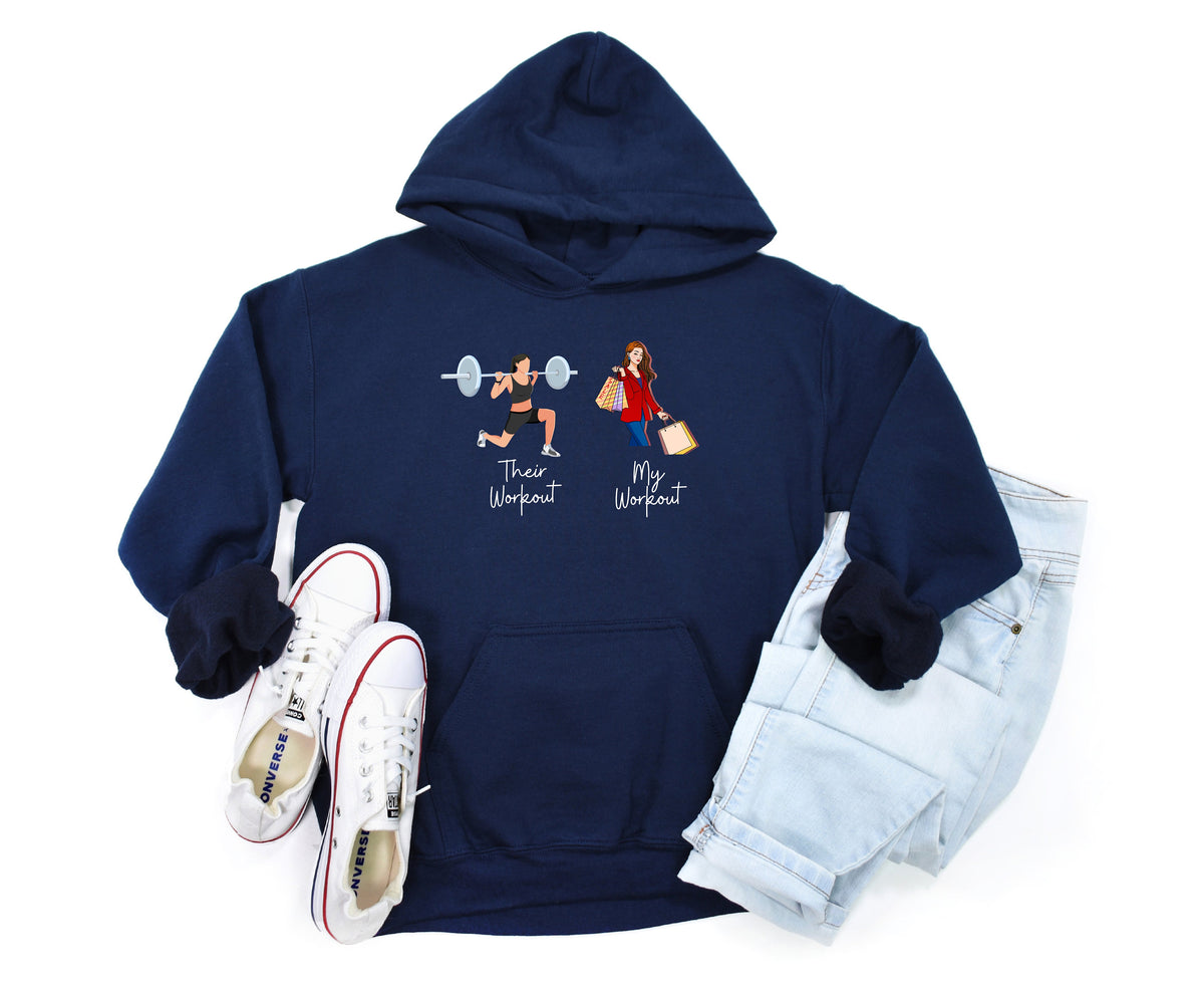 Funny Fitness Hoodie in navy, flat-laid with white sneakers left and light jeans right, showing gym vs shopping workout graphics.