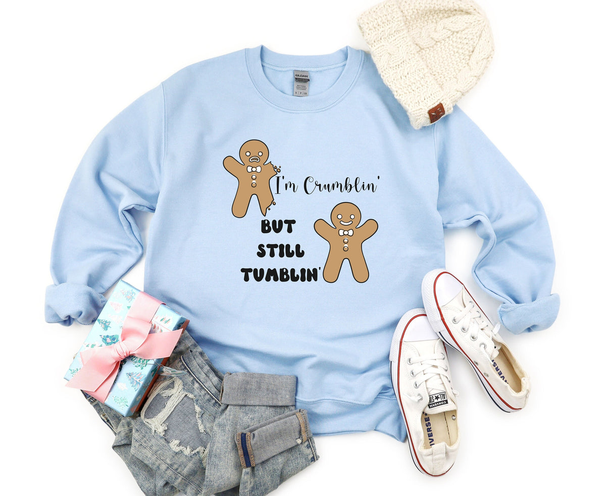 Funny Gingerbread Man Sweatshirt in light blue flat-laid from above with beanie, gift, jeans and sneakers nearby.