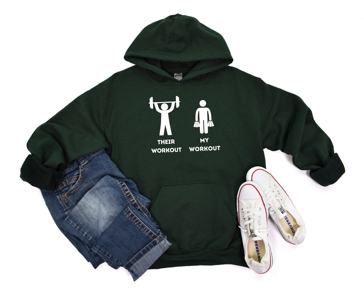 Funny Workout Hoodie in forest green, flat lay with jeans left and white sneakers right, front view of weightlifter vs shopping icons.
