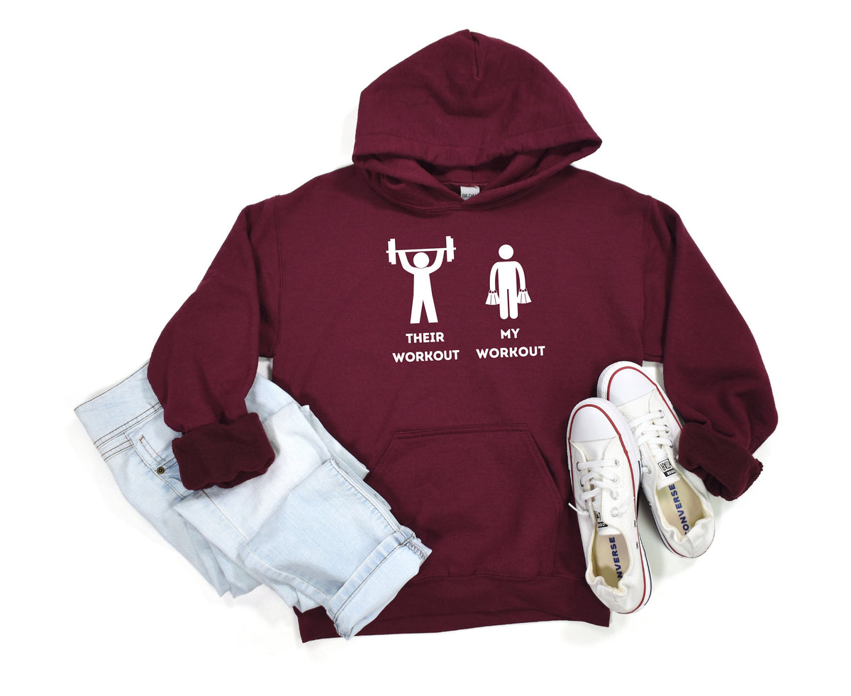 Funny Workout Hoodie in maroon laid flat with folded jeans and white sneakers.