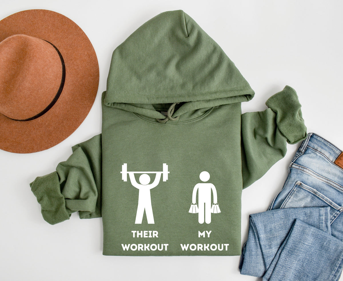 Funny Workout Hoodie in Military Green laid flat from above beside a brown hat and blue jeans.
