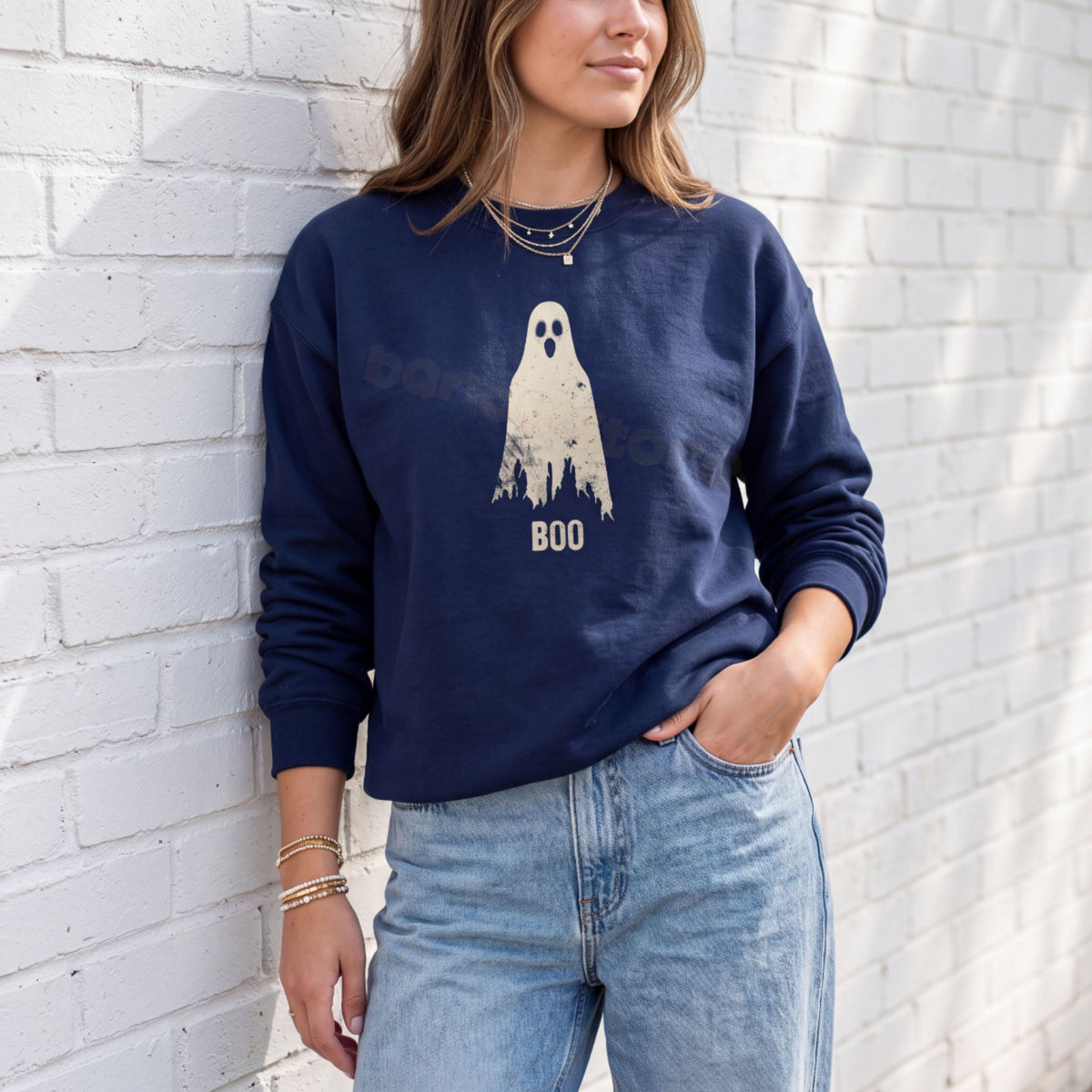 Grungy Ghost Sweatshirt in navy on a woman leaning against a white brick wall.