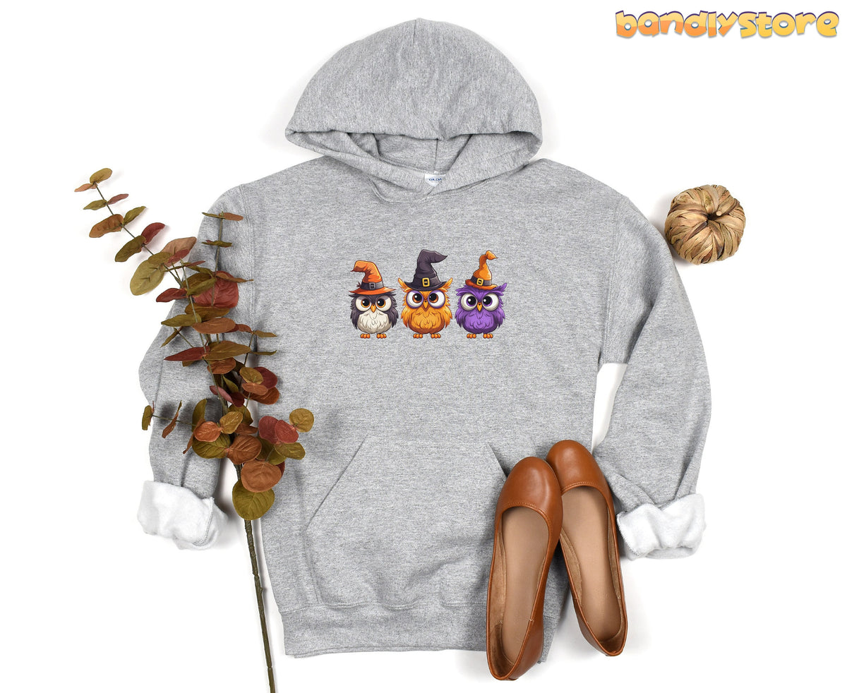 Halloween Owl Hoodie in Sport Grey flat-laid with leafy branch, pumpkin and brown shoes.