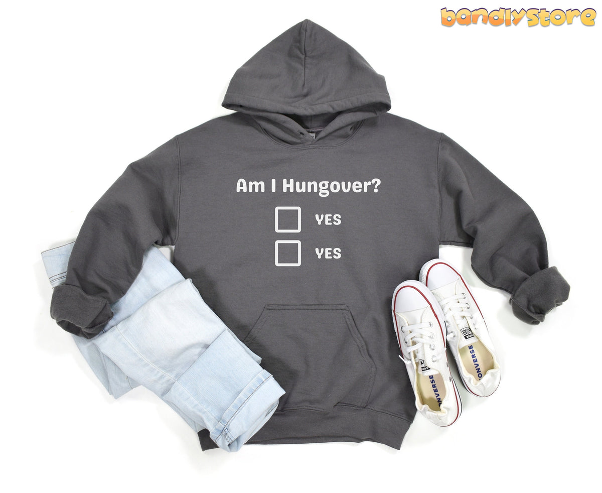 Hangover Hoodie charcoal flat lay with folded light jeans left and white sneakers right on plain white.