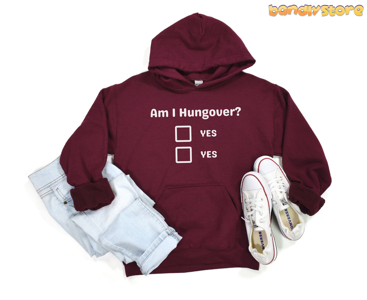 Hangover Hoodie in maroon, flat-laid with light-wash jeans left and white sneakers right.
