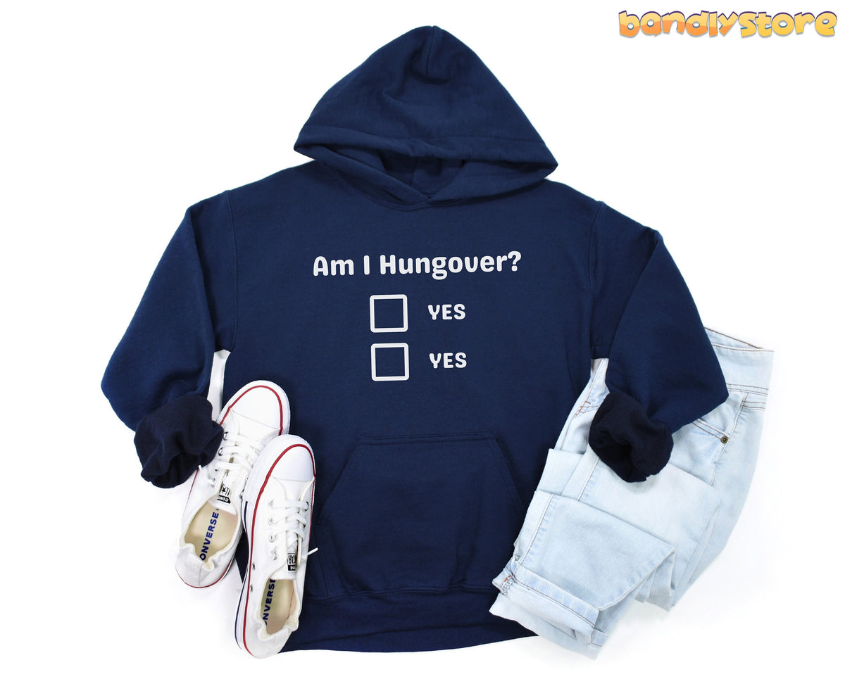 Hangover Hoodie in navy flat-laid from above beside white sneakers and jeans on a white background.