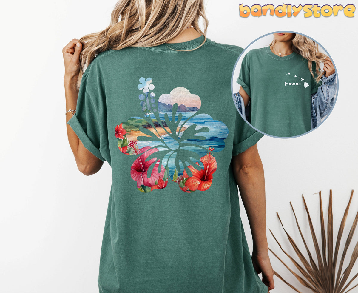 Hawaii Hibiscus T-Shirt with Back Print in Bay from behind on a model with long blonde hair next to a dried leaf.
